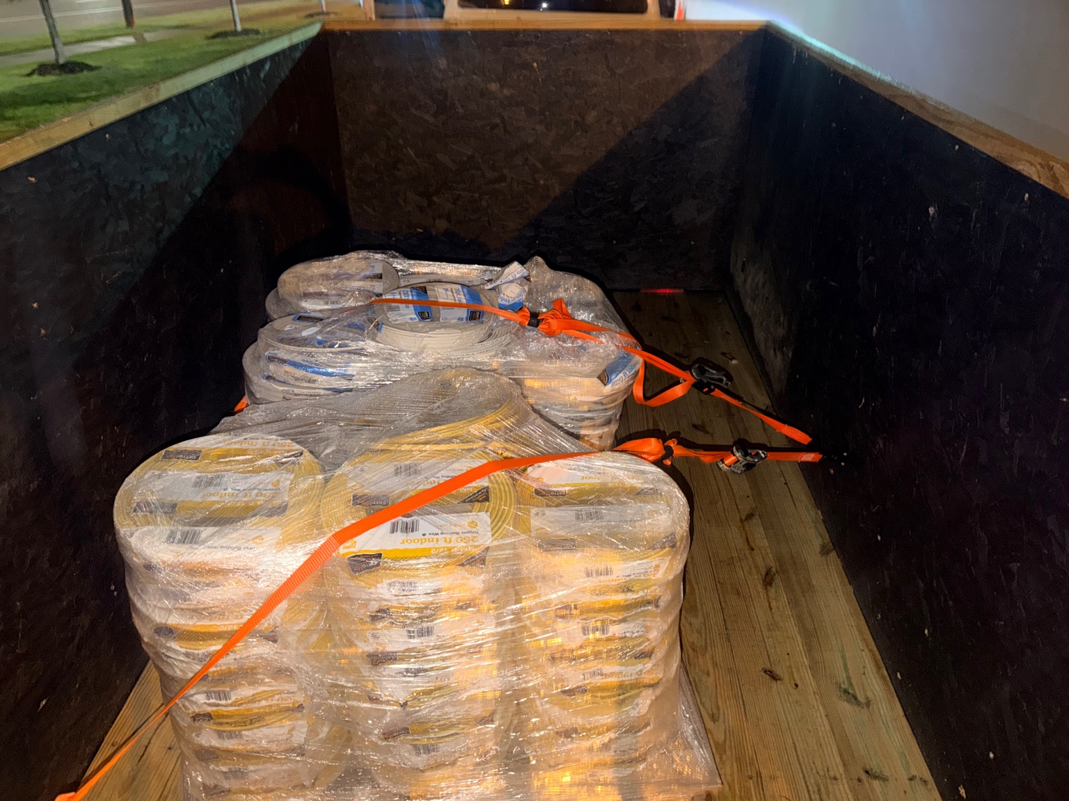 Pallets of wire spools strapped in trailer