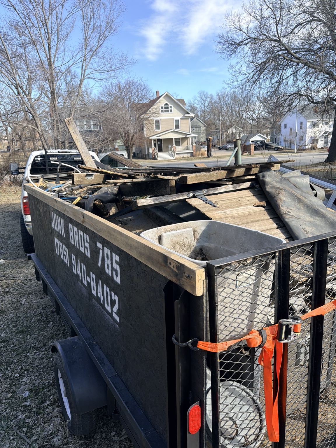 Junk Bros 785 trailer loaded with renovation debris